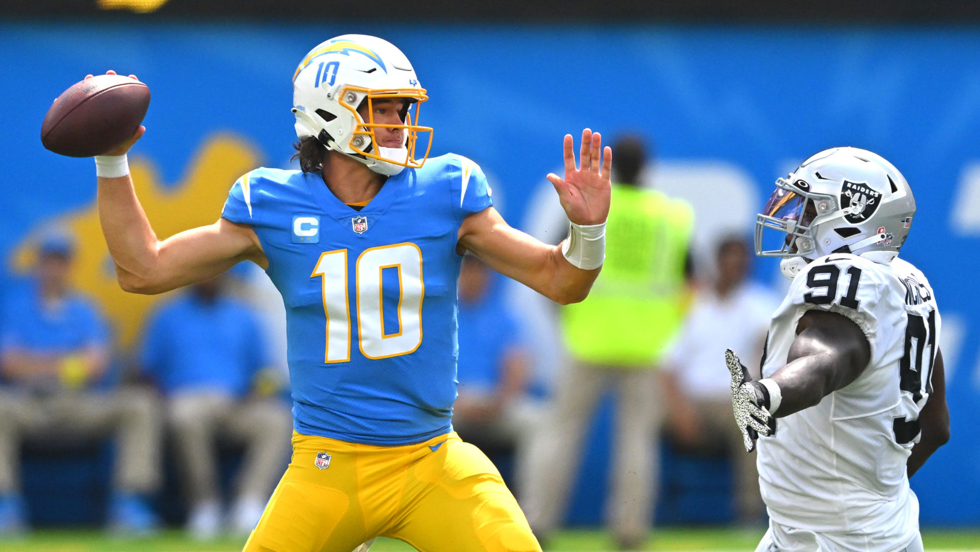 Justin Herbert throwing past Bilal Nichols