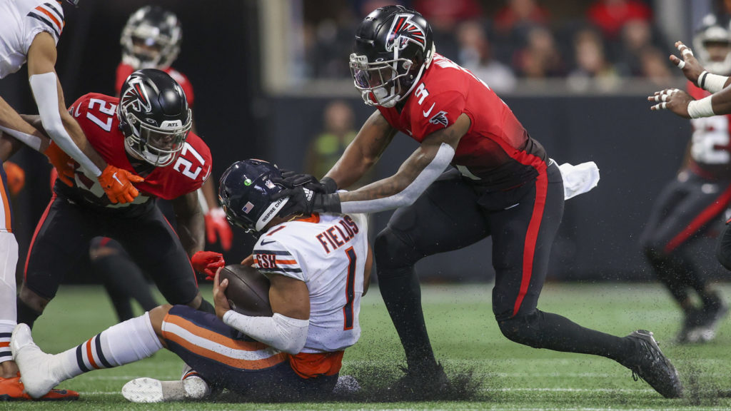 Justin Fields gets tackled by Atlanta Falcons player.