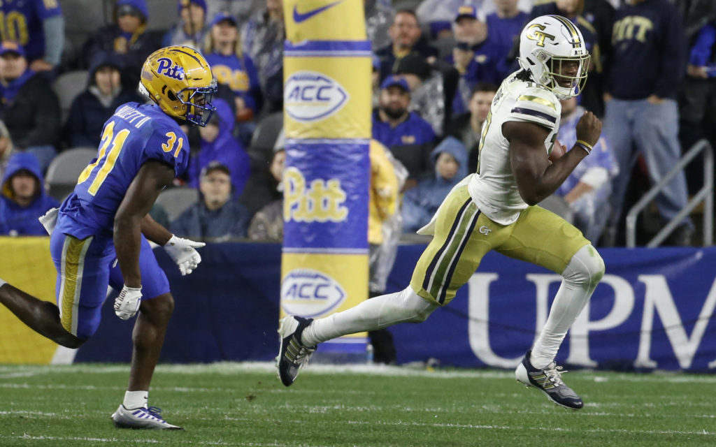 Oct 1, 2022; Pittsburgh, Pennsylvania, USA; Georgia Tech Yellow Jackets quarterback Jeff Sims (10) runs with the ball against Pittsburgh Panthers defensive back Erick Hallett II (31) during the first quarter at Acrisure Stadium. Mandatory Credit: Charles LeClaire-USA TODAY Sports