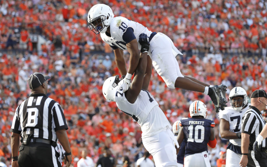 Sep 17, 2022; Auburn, Alabama, USA; Penn State Nittany Lions running back Nicholas Singleton (10) celebrates with offensive lineman Olumuyiwa Fashanu (74) after scoring a touchdown against the Auburn Tigers during the third quarter at Jordan-Hare Stadium. Mandatory Credit: John Reed-USA TODAY Sports