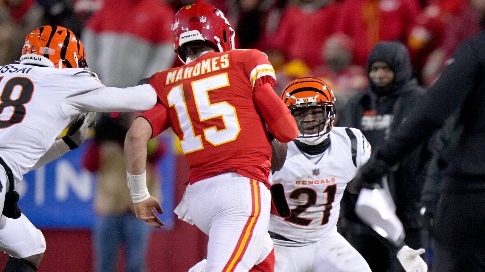 The Cincinnati Bengals' Joseph Ossai pursues Kansas City Chiefs quarterback Patrick Mahomes to the sideline