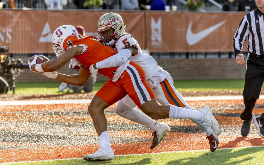 Feb 4, 2023; Mobile, AL, USA; National wide receiver Michael Wilson of Stanford (4) grabs pass and runs it in to the end zone for a touchdown despite the effort of American defensive back Jammie Robinson of Florida State (5) during the second half of the Senior Bowl college football game at Hancock Whitney Stadium. Mandatory Credit: Vasha Hunt-USA TODAY Sports