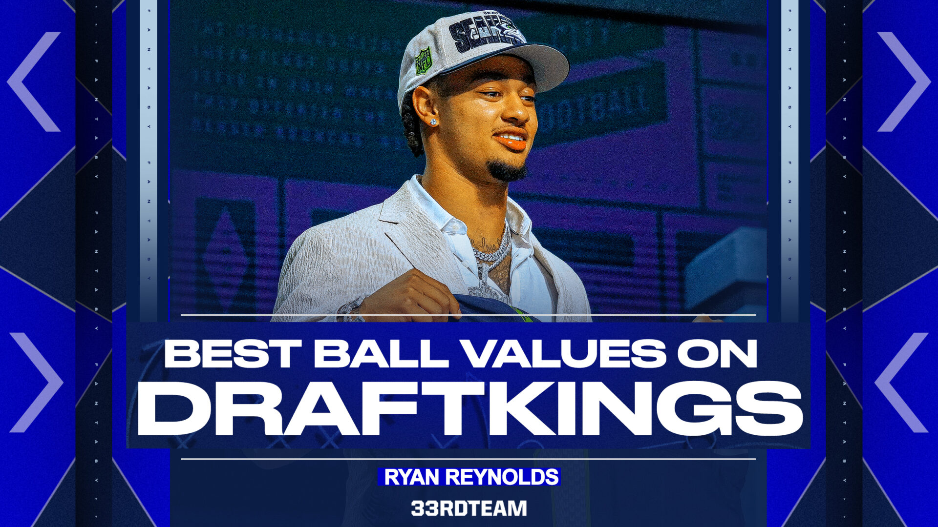 Image of Jaxon Smith-Njigba at the NFL draft holding up his Seattle Seahawks jersey. The text reads: "Best Ball Values on DraftKings; Ryan Reynolds; The 33rd Team”