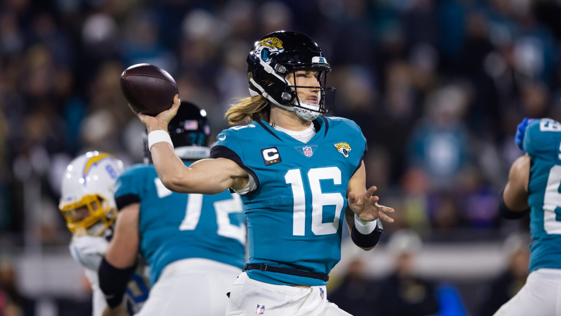 Jacksonville Jaguars quarterback Trevor Lawrence throwing the ball in his team's teal-and-white uniform