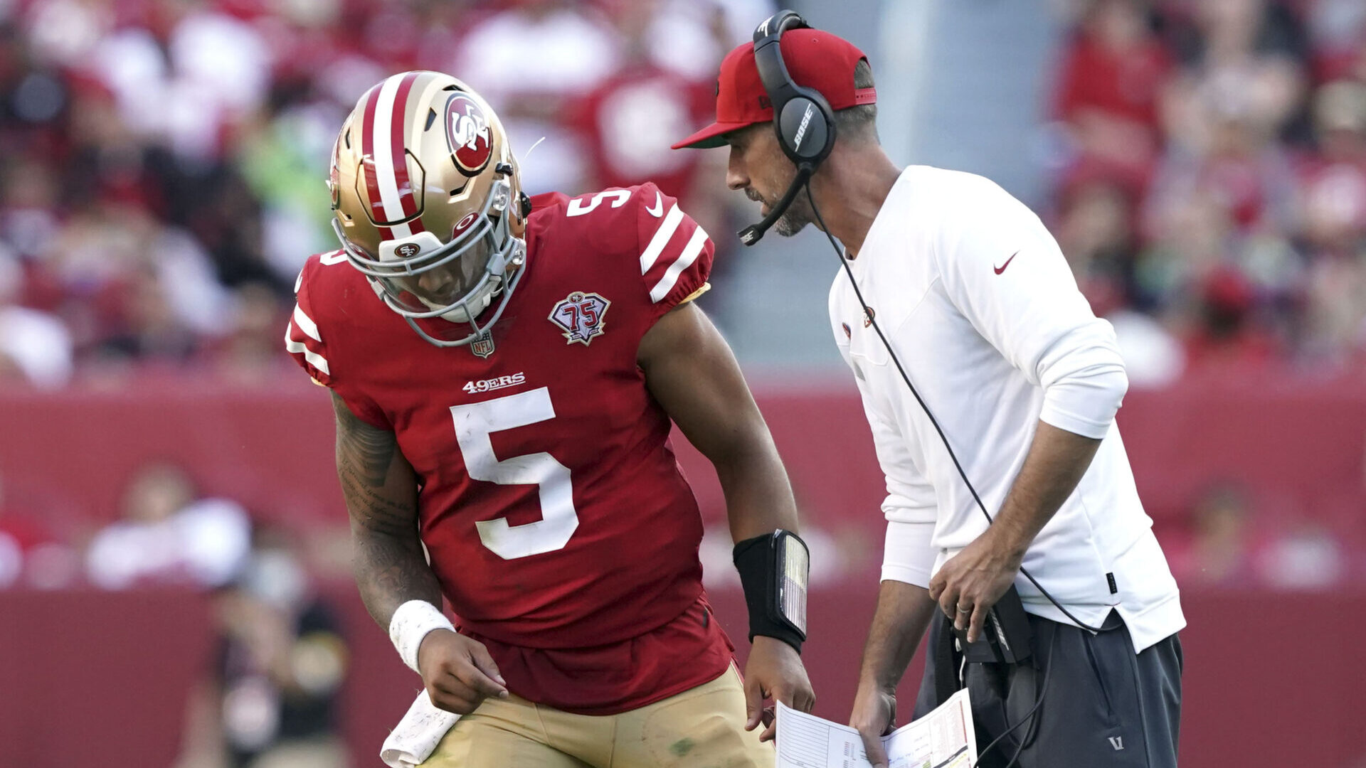 San Francisco 49ers head coach Kyle Shanahan talks to quarterback Trey Lance