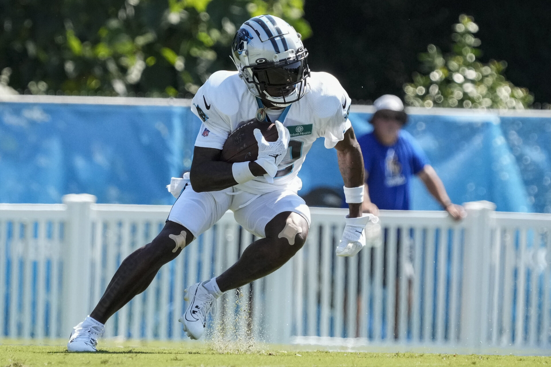 Jonathan Mingo makes a cut in a white practice uniform