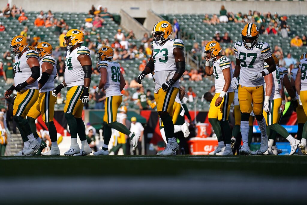 A far-away shot showing the Green Bay Packers and a sparse crowd