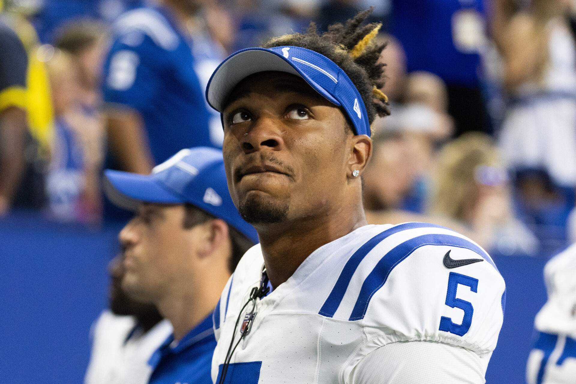 A close-up shot of Anthony Richardson on the bench with his helmet off as he's looking up and away