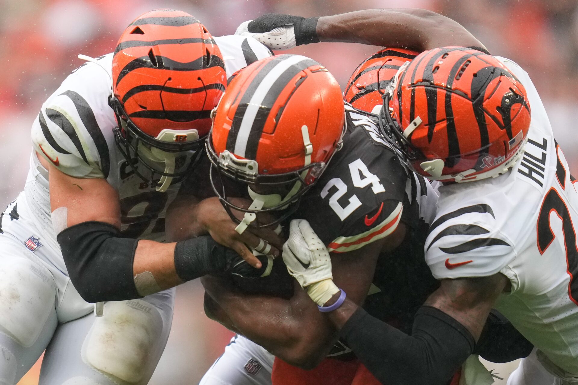 Close up shot of Nick Chubb being tackled by two Cleveland defenders