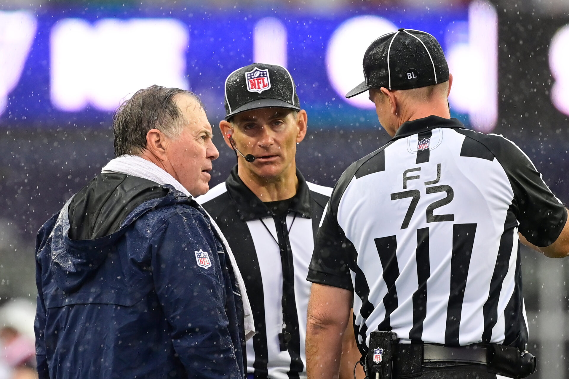 Officials confer with Bill Belichick