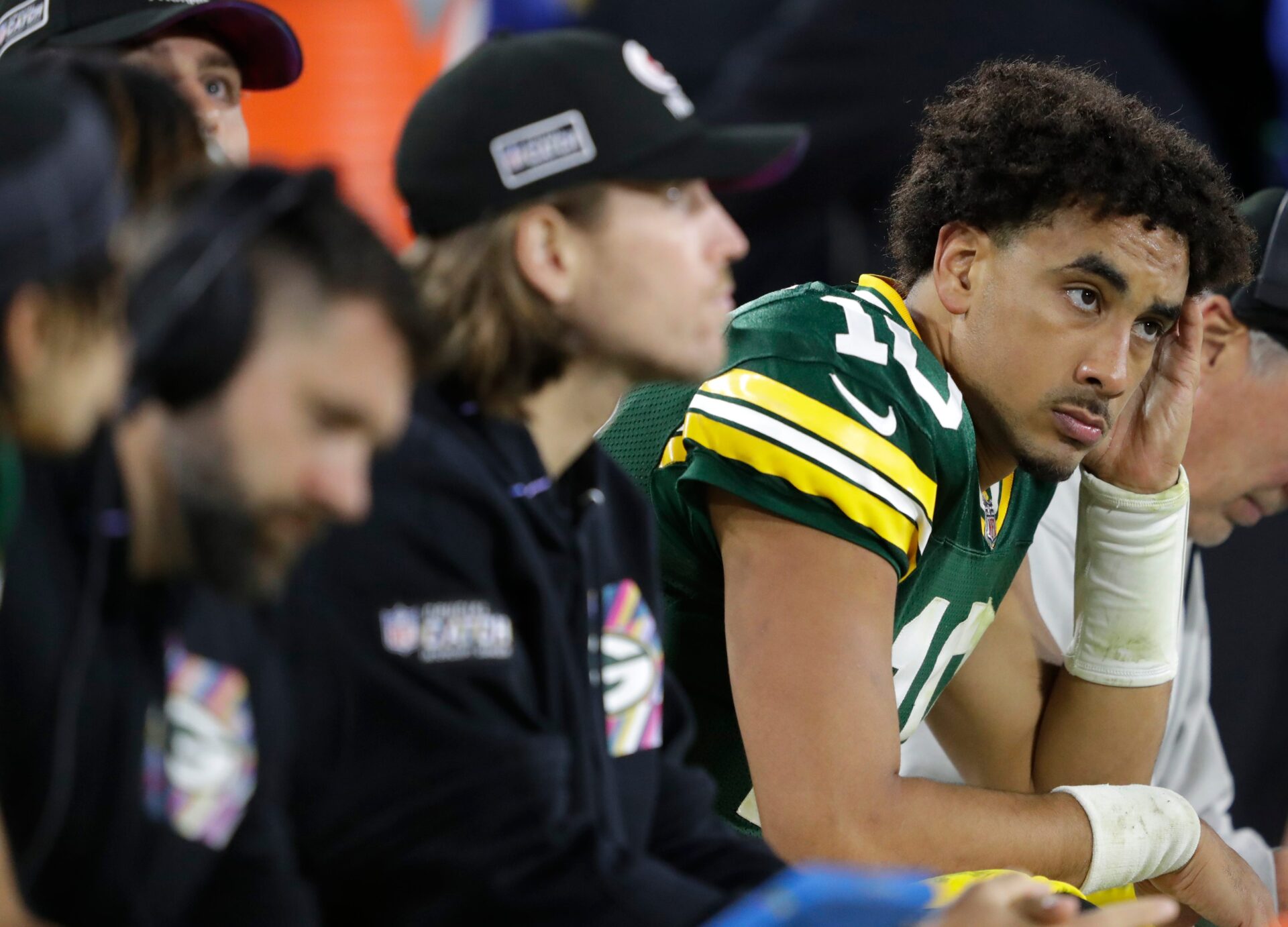 Jordan Love sits on the Packers bench with his helmet off