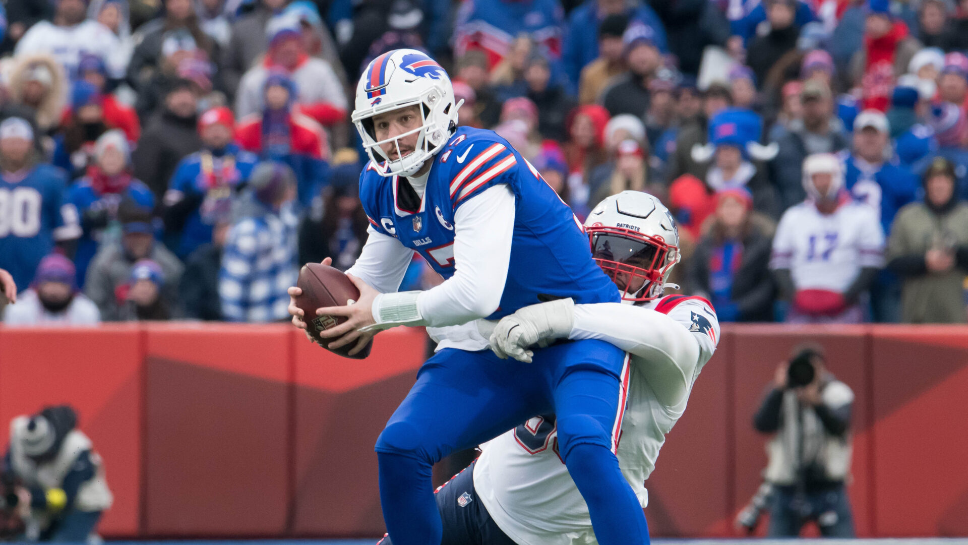 Patriots IDL Daniel Ekuale attempts to tackle Bills QB Josh Allen. 