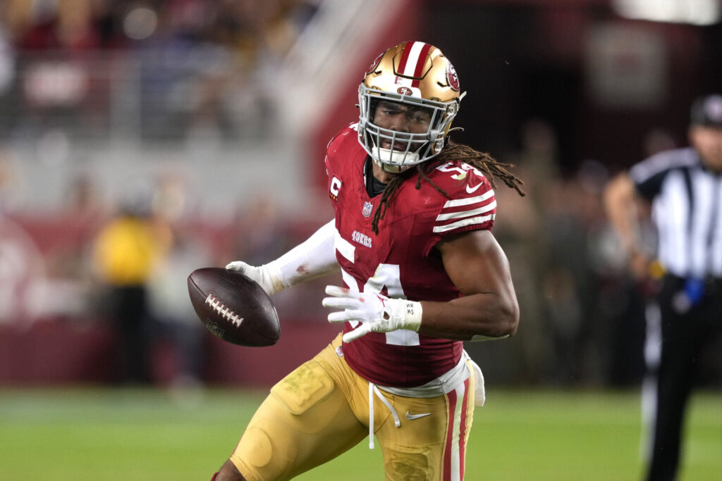 Fred Warner runs back with the ball in his right hand