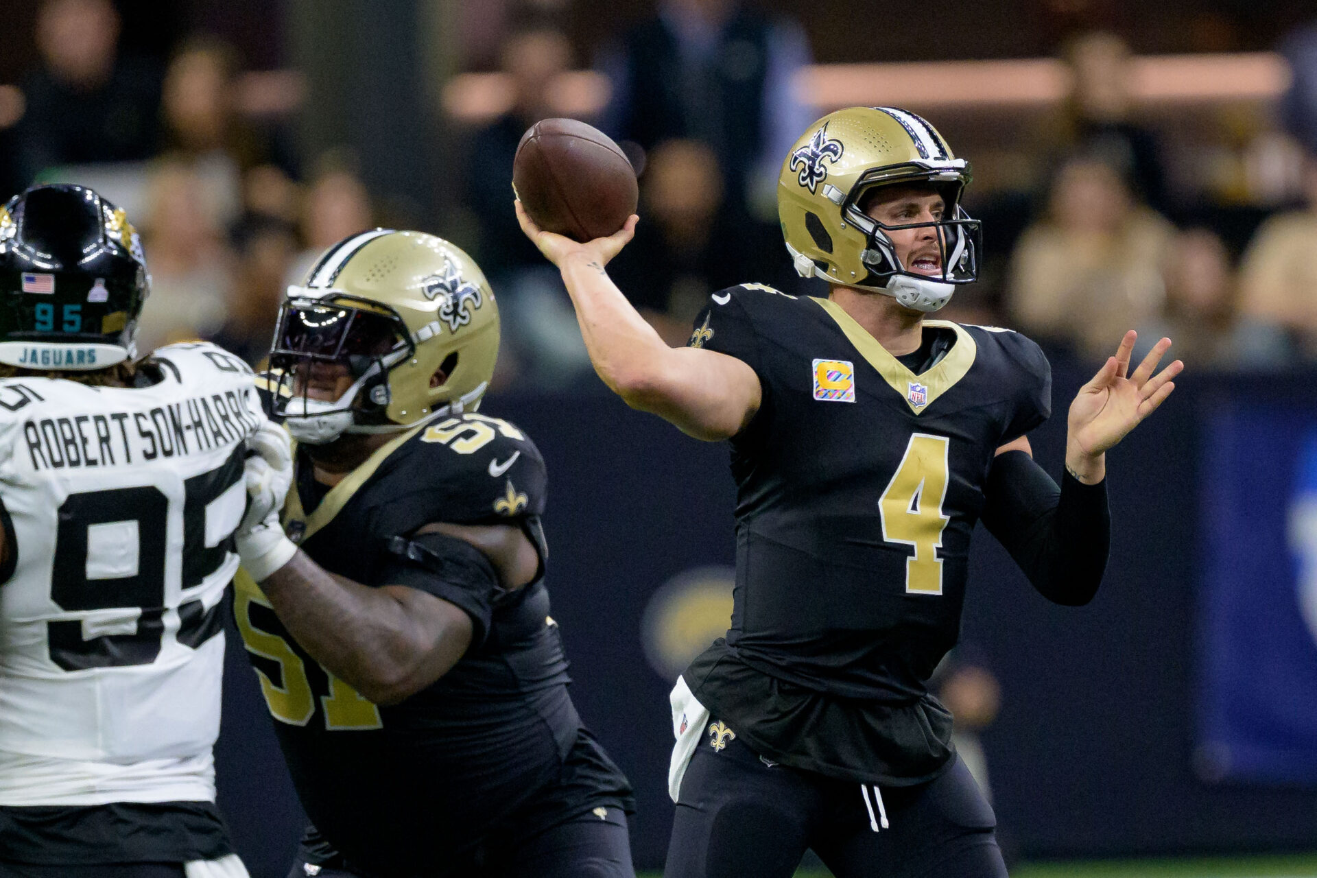 Upper-body image of Derek Carr in his throwing motion