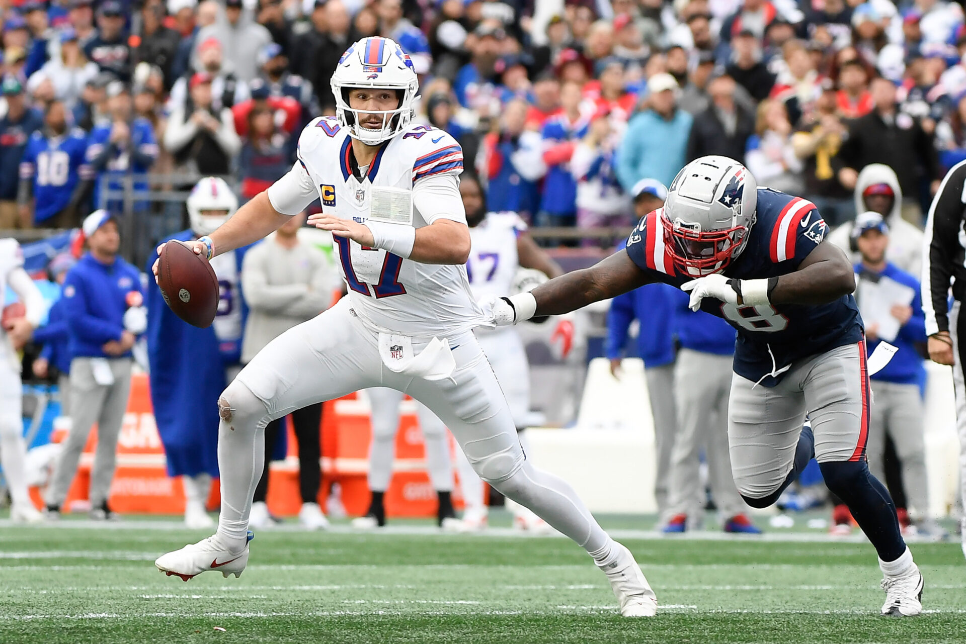 Josh Allen escapes the outstretched arms of a Patriots defender