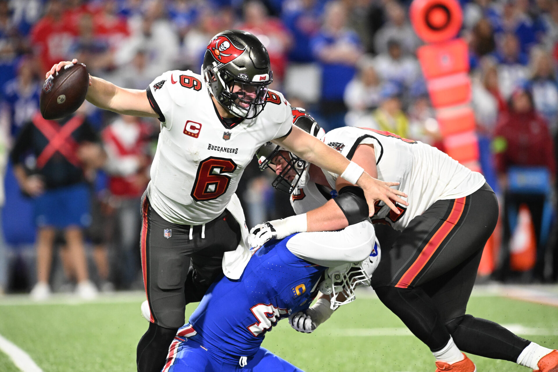 Baker Mayfield tries to escape pressure while his offensive line tries to contain Von Miller