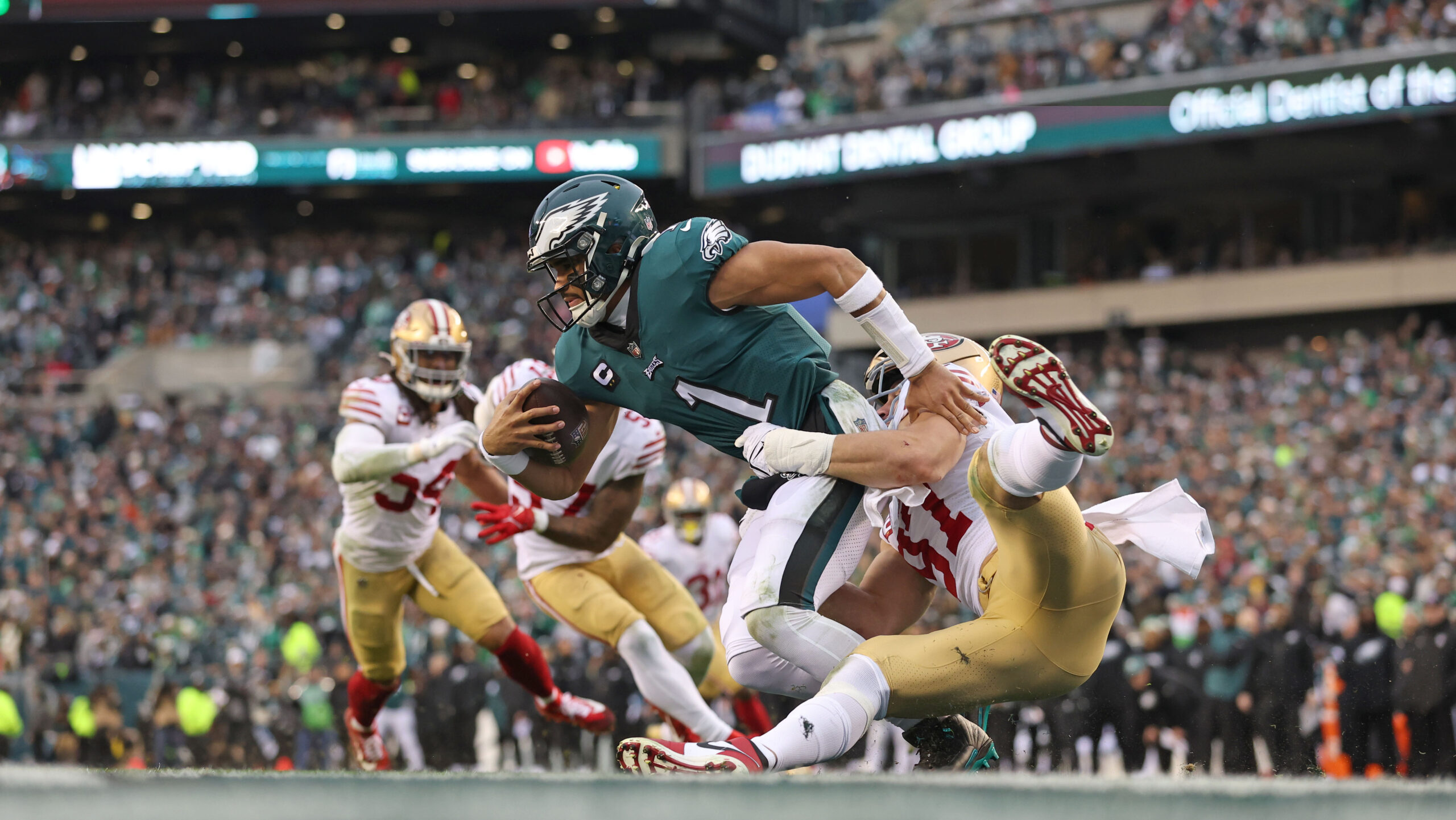 Jalen Hurts is tackled by Nick Bosa