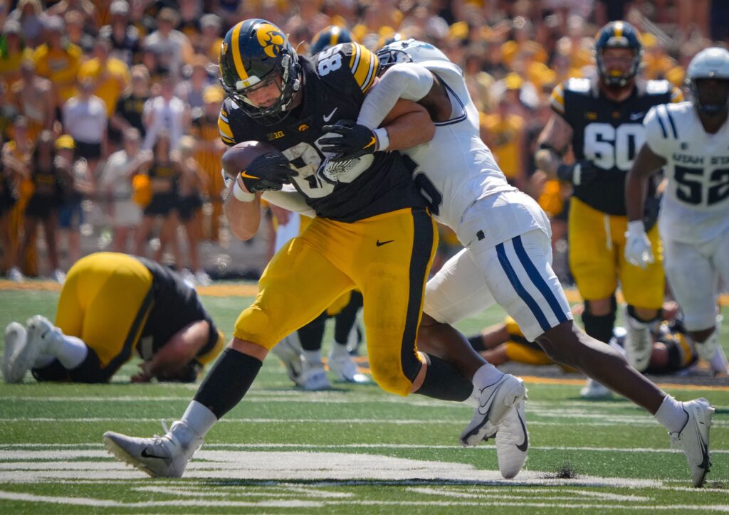 Iowa's Luke Lachey fights through a tackle