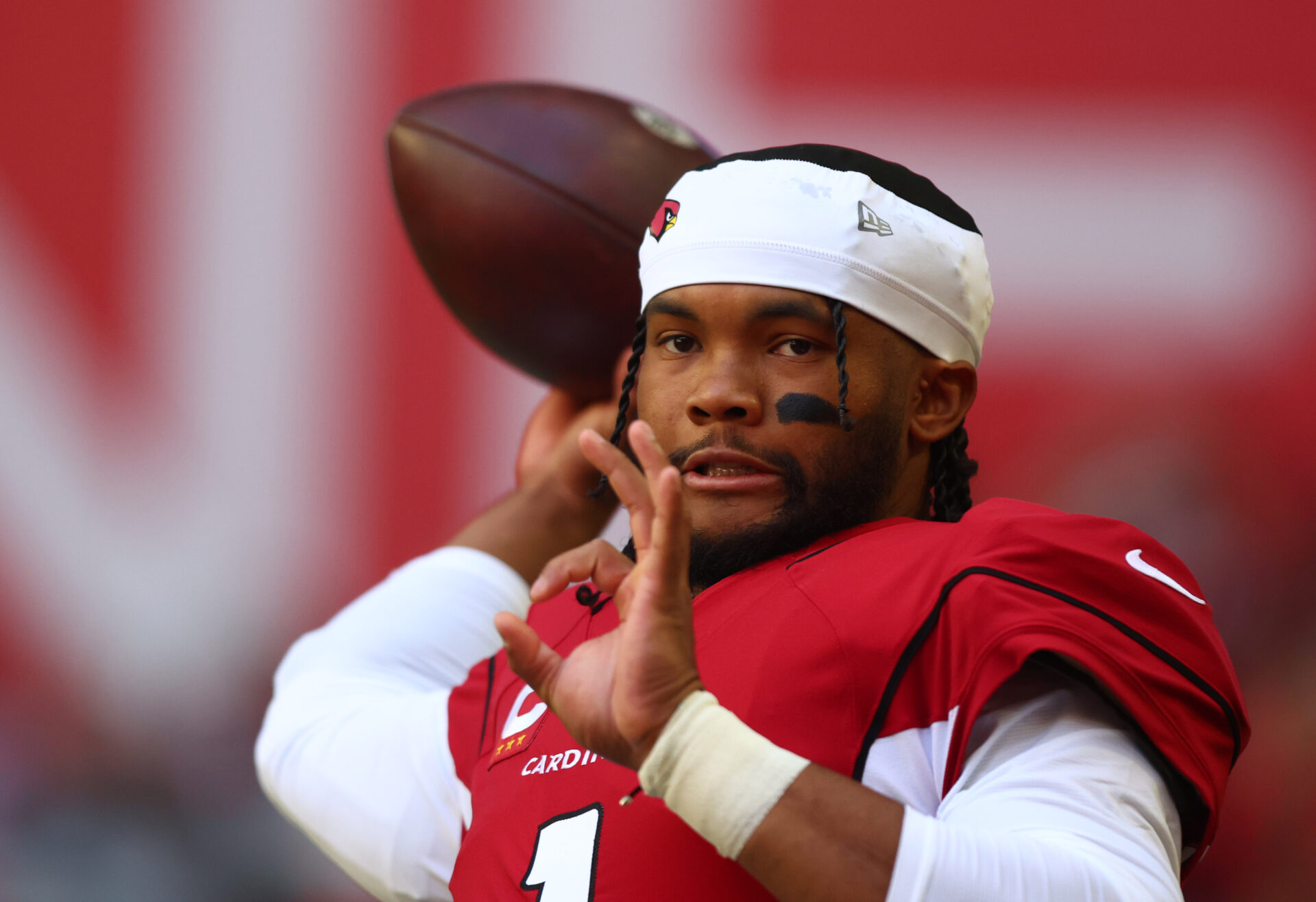 Kyler Murray throwing a ball on the sideline