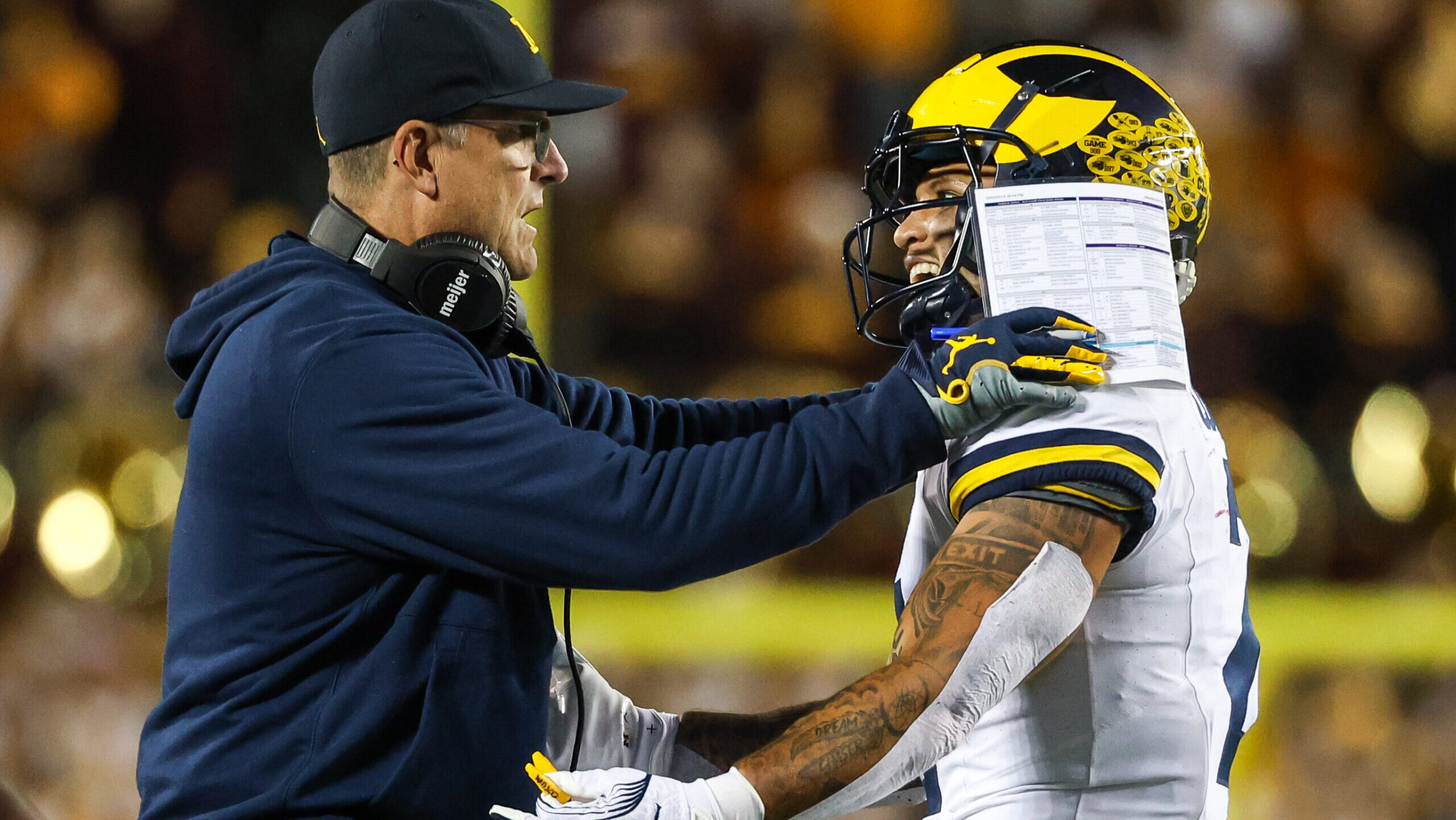 Michigan Wolverines running back Blake Corum celebrates with head coach Jim Harbaugh