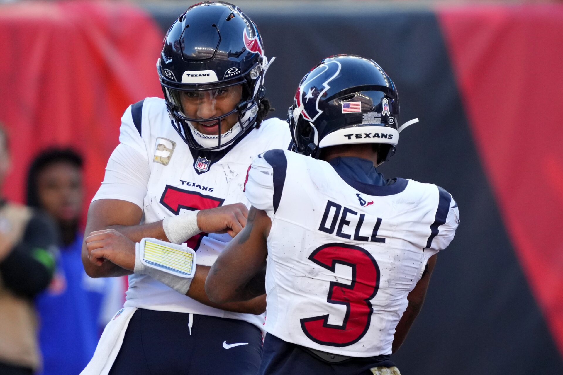 C.J. Stroud (facing the camera) and Tank Dell (with his back to the camera) celebrate