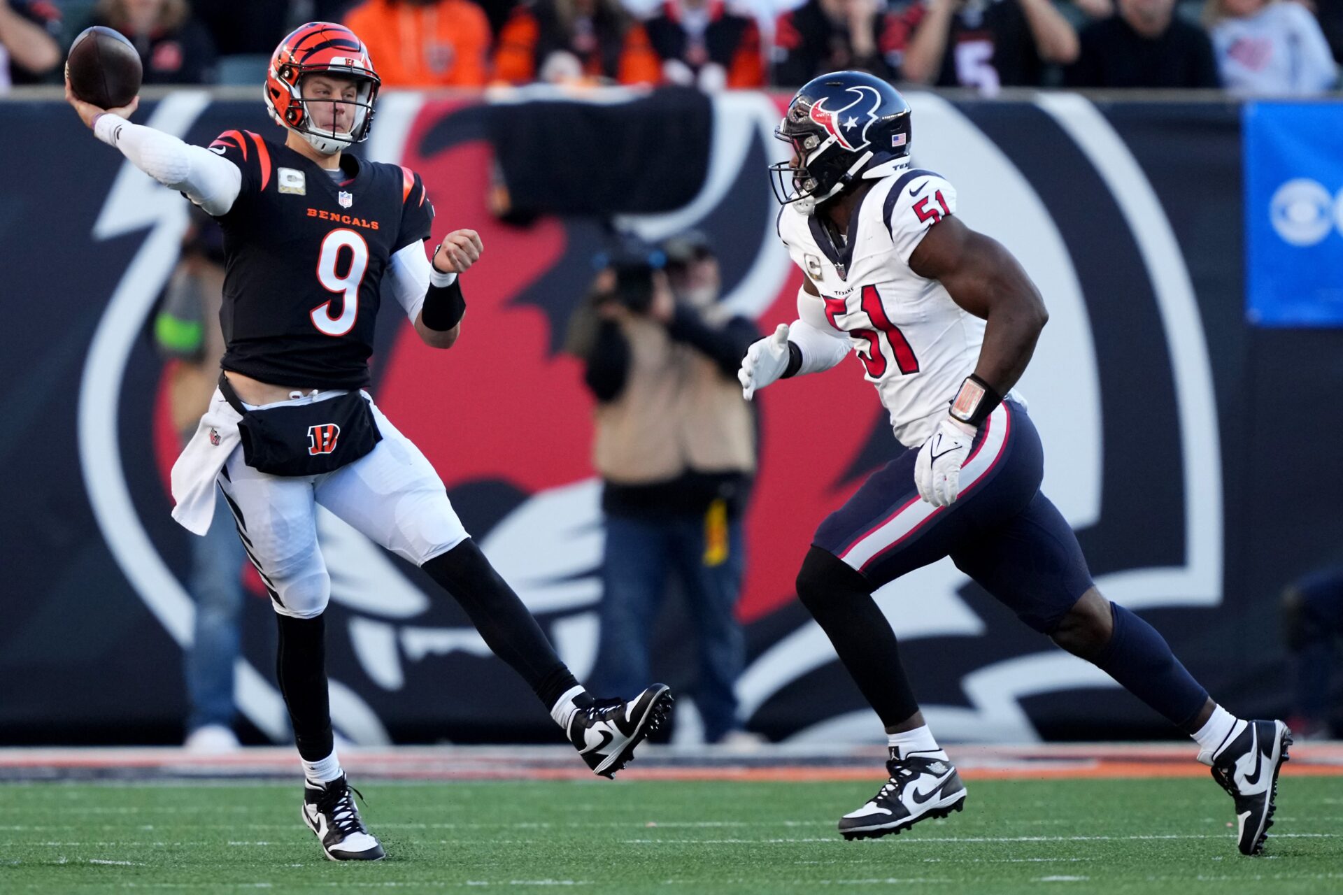 Joe Burrow makes an off-balanced throw on the run as he escapes a Texans defender