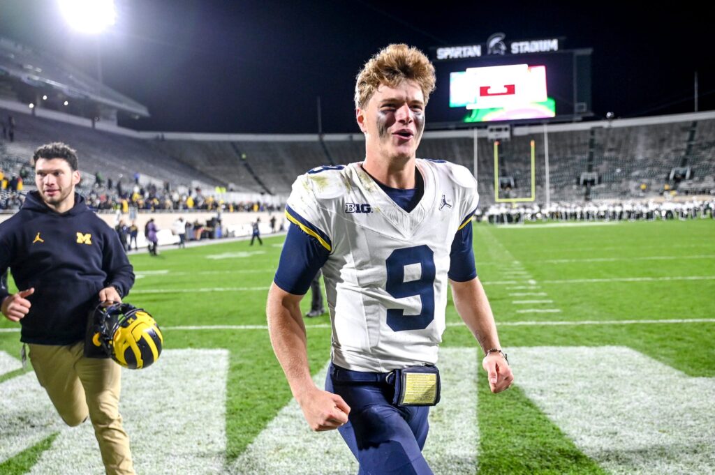 J.J. McCarthy celebrates as he walks off the field