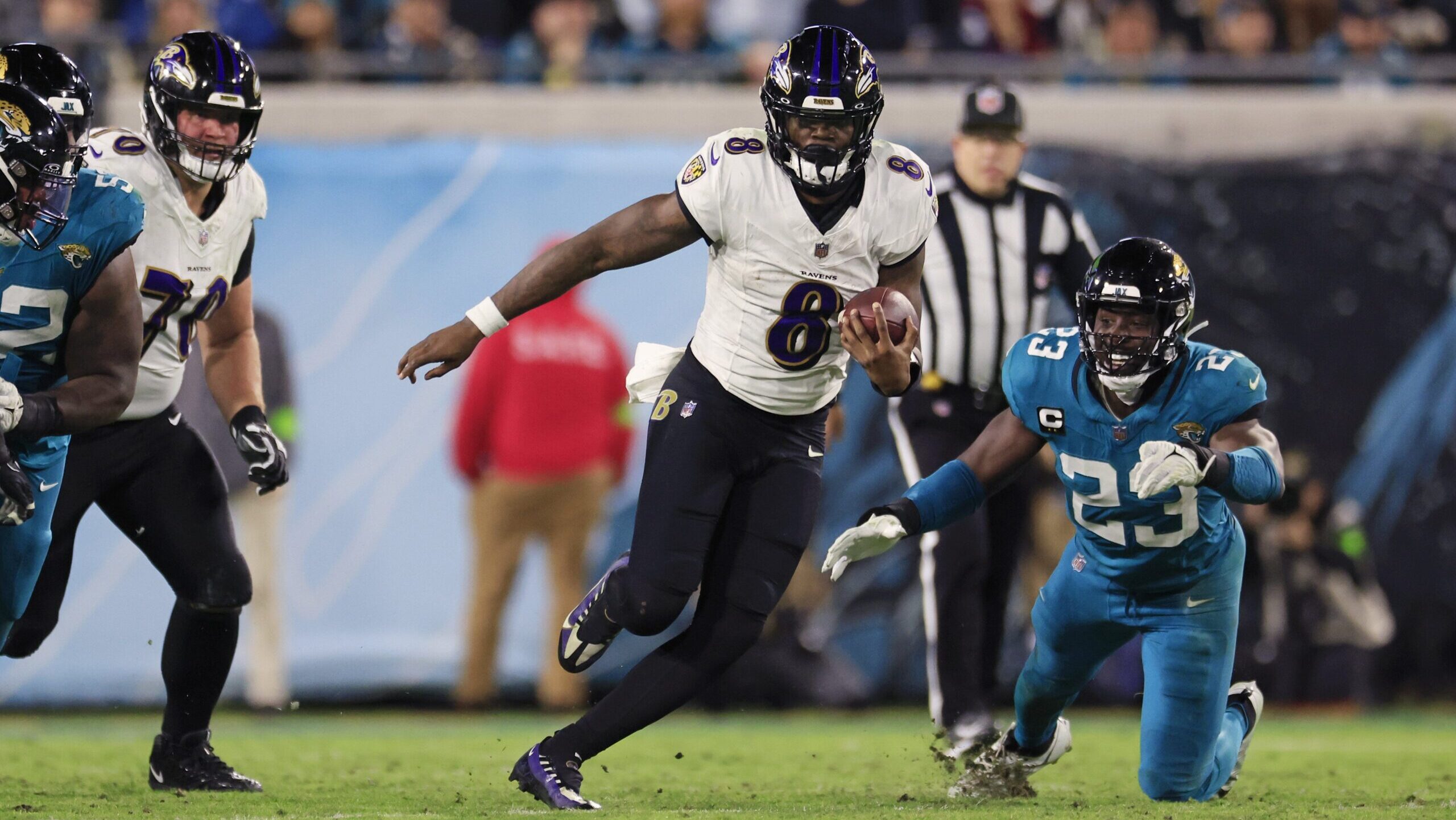 Lamar Jackson runs away from Jaguars defenders