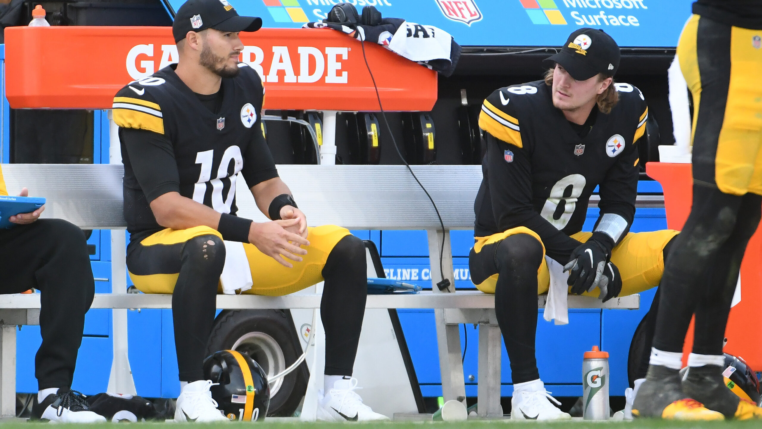 Mitch Turbisky sits with Kenny Pickett on Steelers sideline.