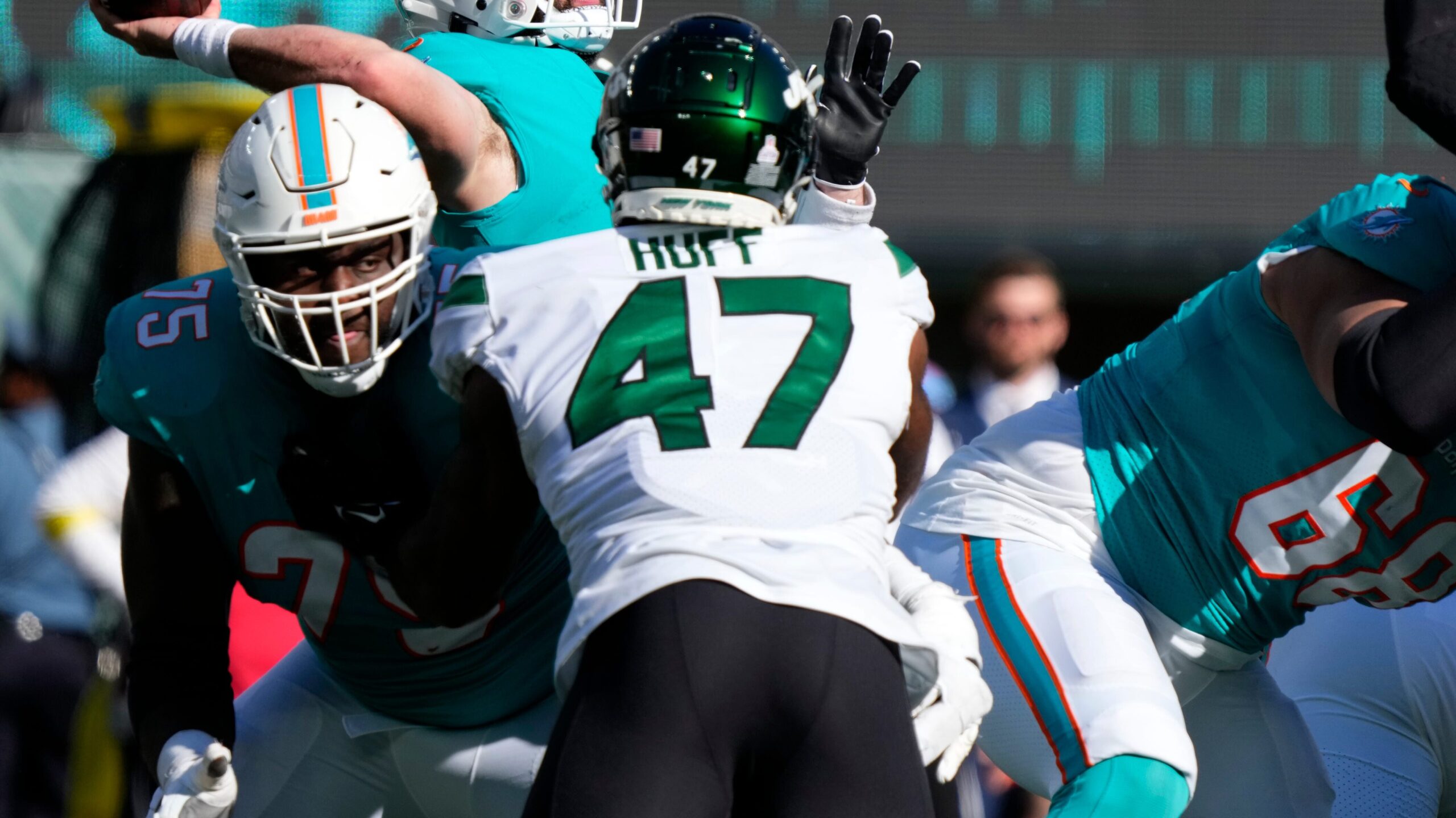 Dolphins quarterback Skylar Thompson (19) tries to make a pass in the fourth quarter as Dolphins tackle Greg Little (75) blocks Jets defensive lineman Bryce Huff