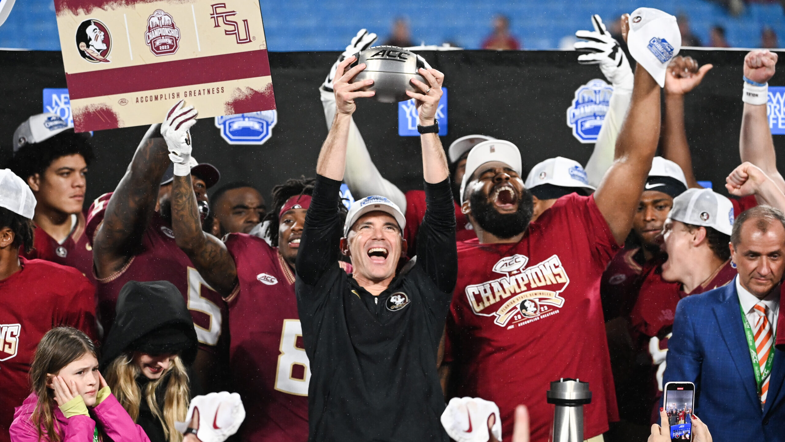 Florida State Seminoles head coach Mike Norvell raises the ACC Championship trophy