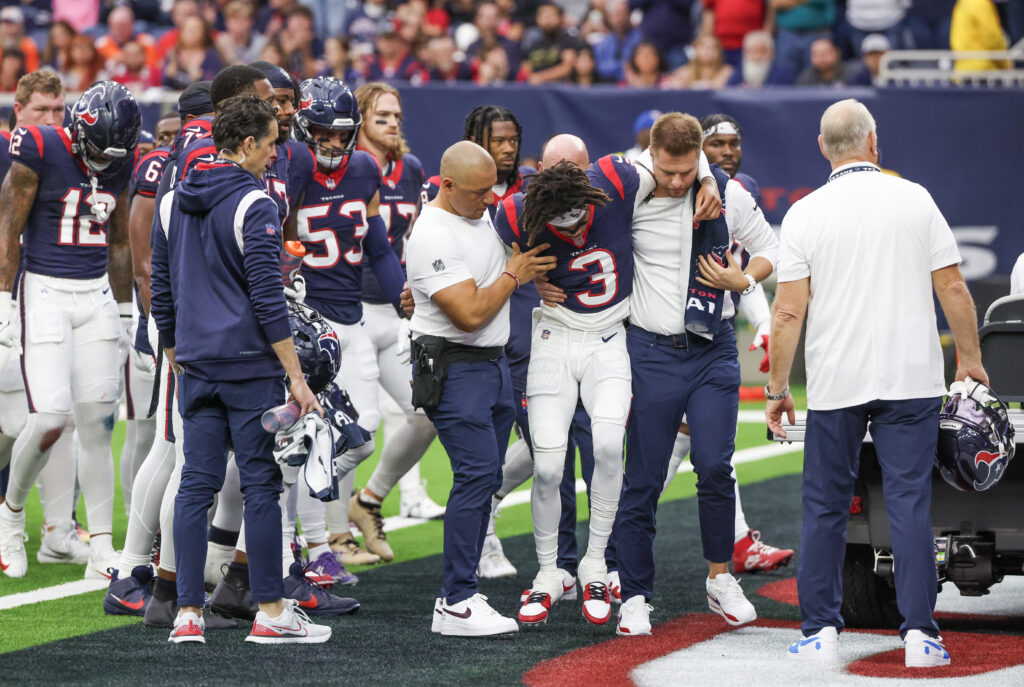 Tank Dell being helped off the field