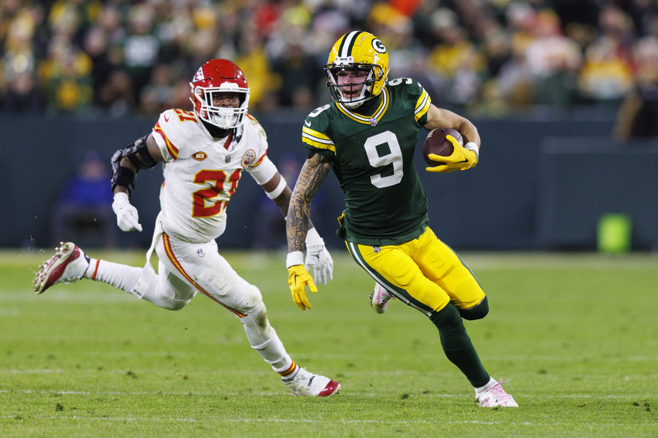 Christian Watson runs away from a Chiefs defender