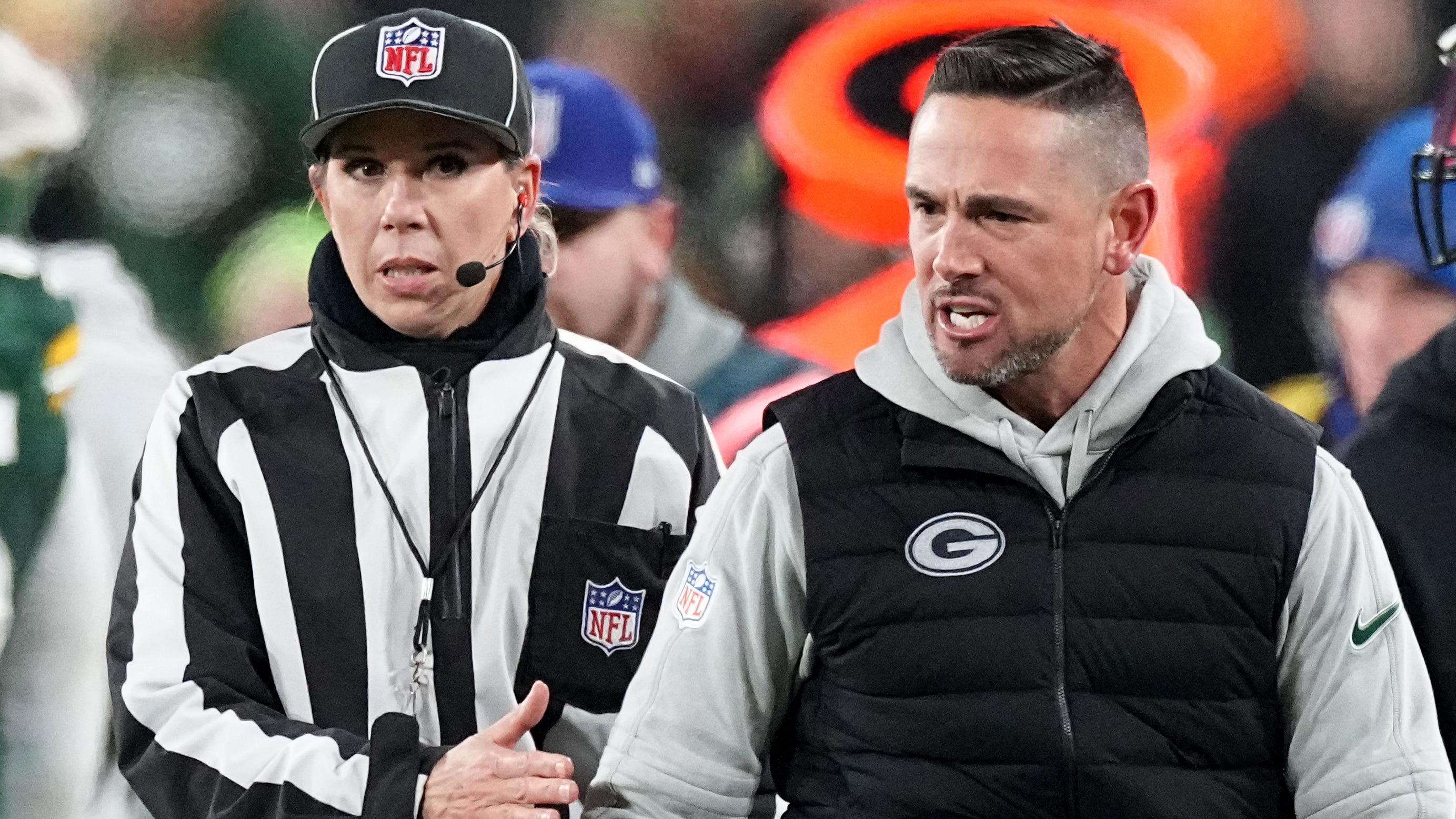 Matt LaFleur looks angry on the sideline as a ref looks on