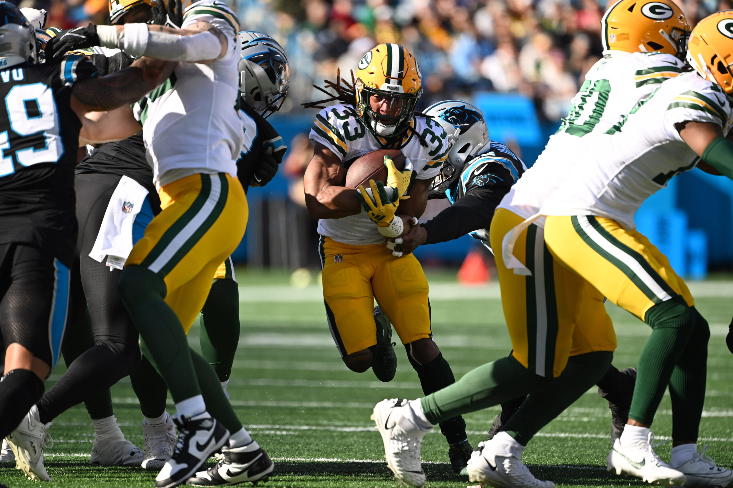 Aaron Jones running through a hole in the Panthers' defense