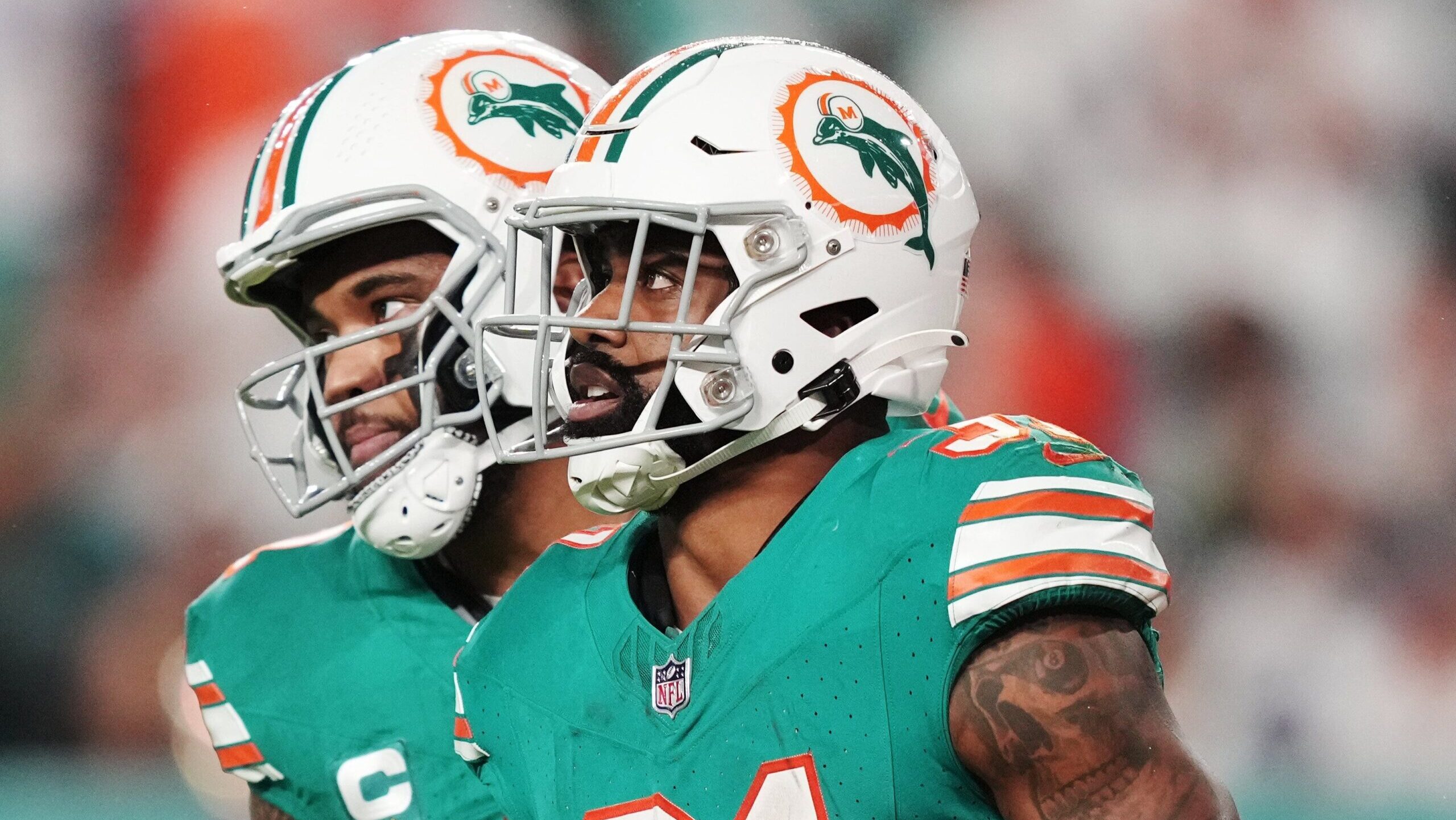 Miami Dolphins quarterback Tua Tagovailoa, left, and running back Raheem Mostert