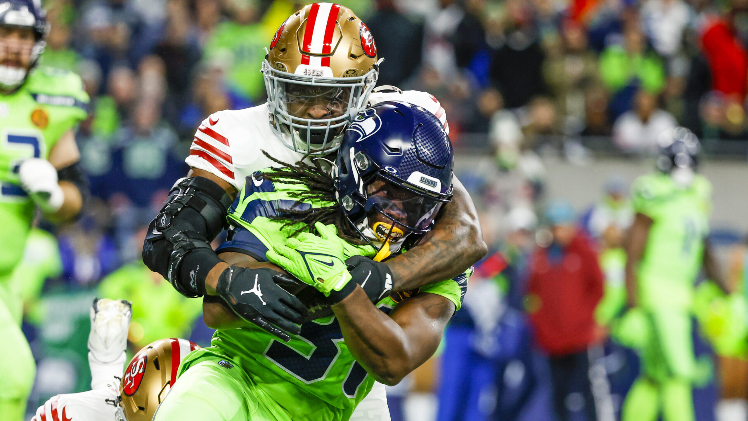 San Francisco 49ers linebacker Dre Greenlaw tackles Seattle Seahawks running back DeeJay Dallas