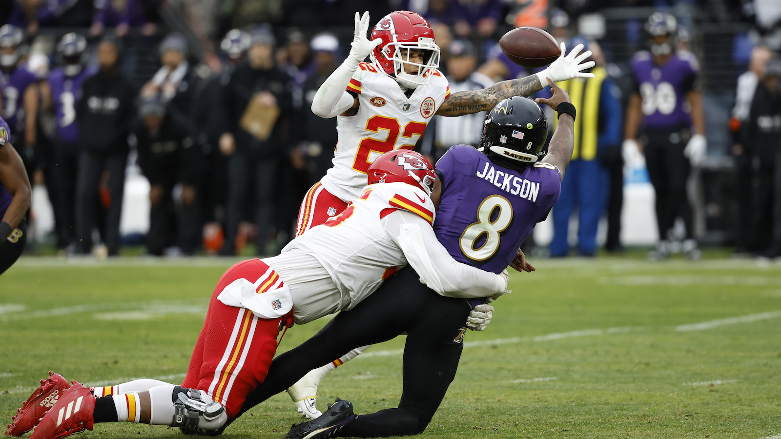Kansas City Chiefs cornerback Trent McDuffie and defensive tackle Chris Jones pressure Baltimore Ravens quarterback Lamar Jackson