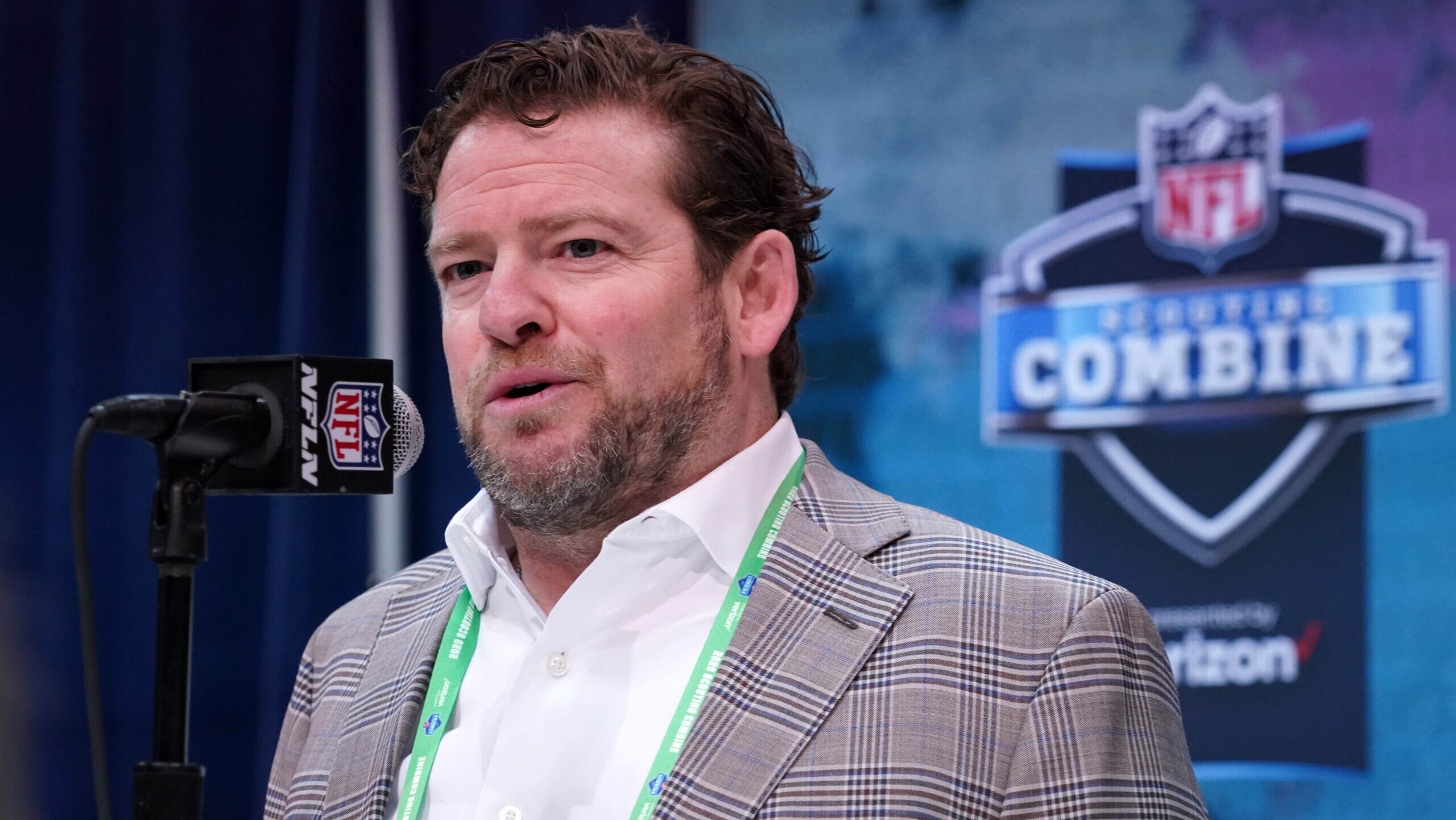 John Schneider stands at the podium at the NFL Combine
