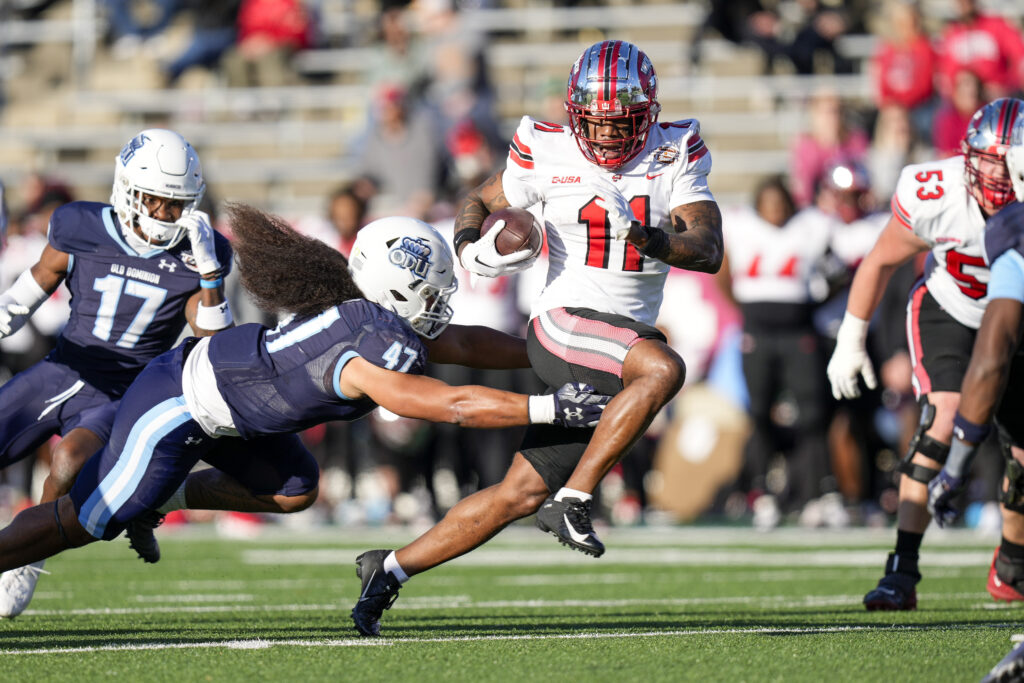 Malachi Corley tries to run away from a defender