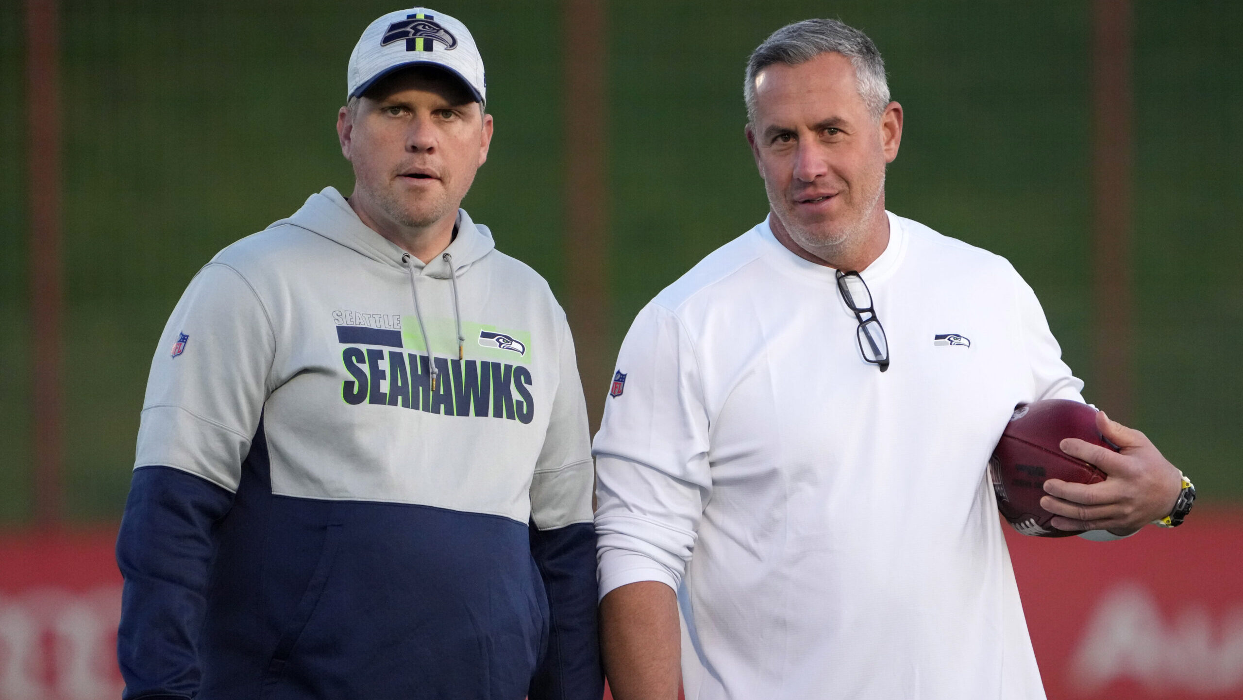 Shane Waldron stands on field with Seahawks tight end coach