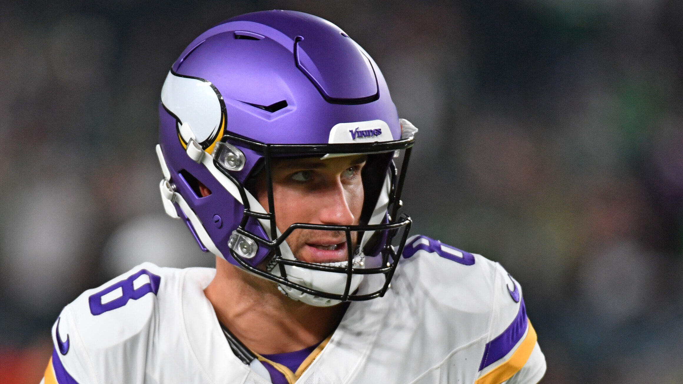 Vikings QB Kirk Cousins looks to his left with his helmet on