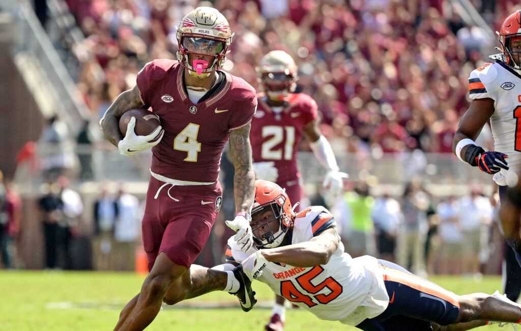 Keon Coleman evades a defender while running with the ball