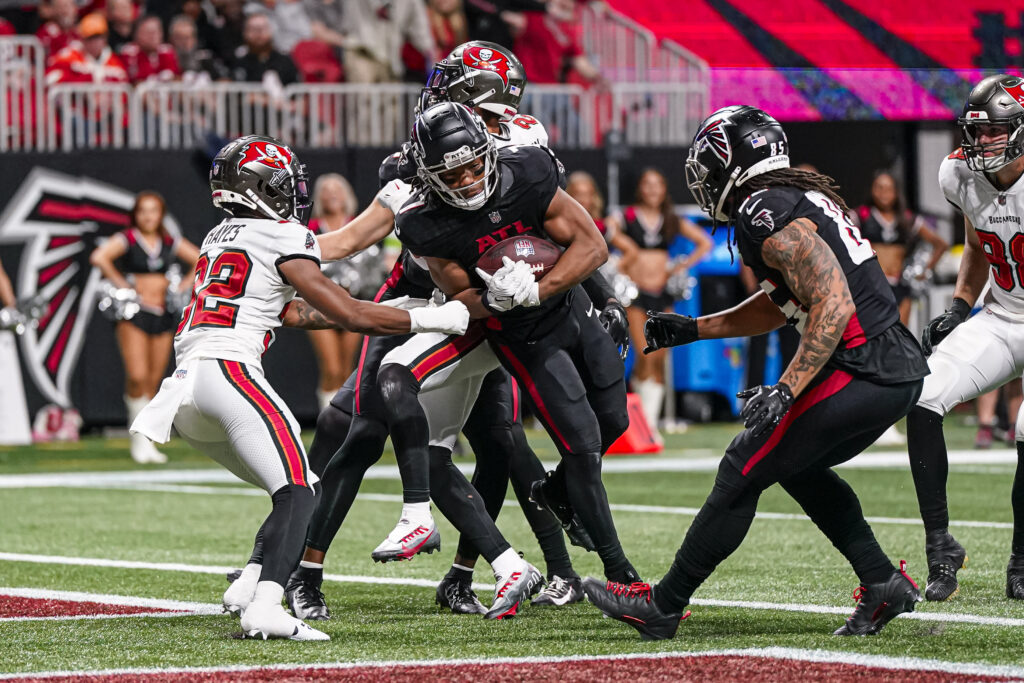 Bijan Robinson in the endzone surrounded by bodies from the Falcons and Buccaneers
