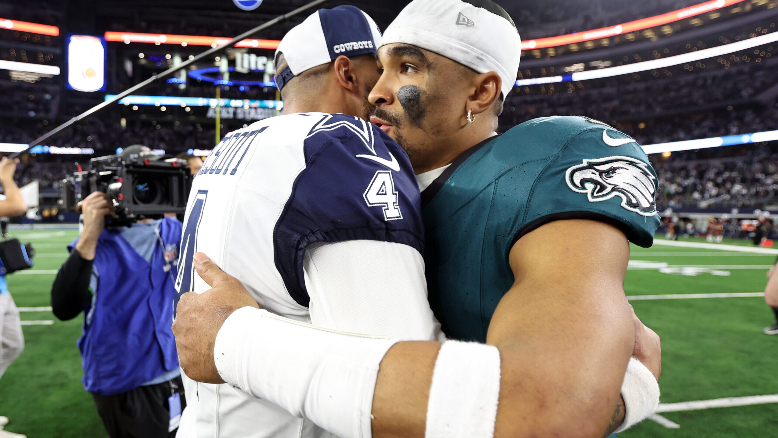 Dallas Cowboys quarterback Dak Prescott (4) hugs Philadelphia Eagles quarterback Jalen Hurts (1)