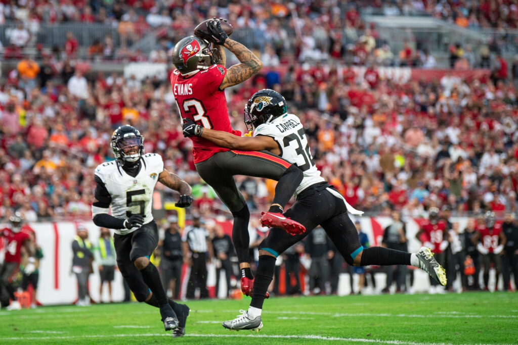 Mike Evans leaps up for a catch with a Jaguars player's hands on him