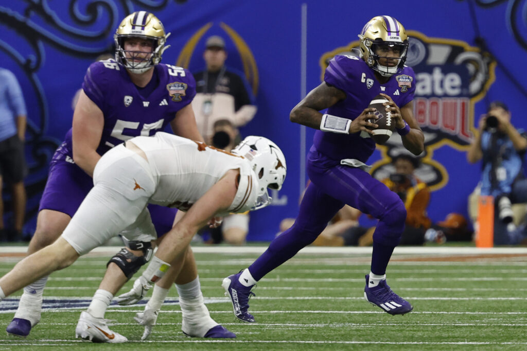 Michael Penix Jr. runs with the ball