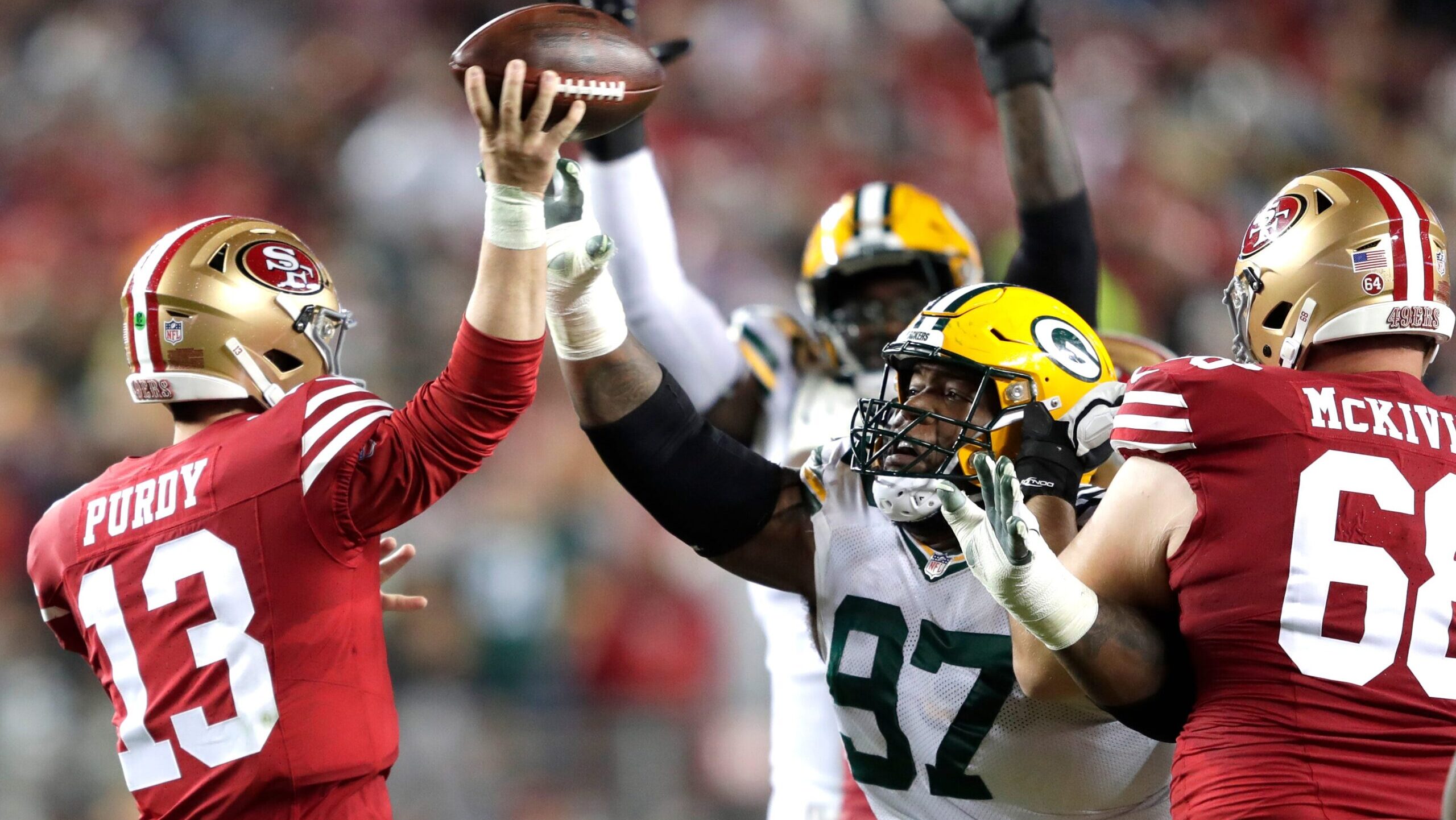 Green Bay Packers defensive tackle Kenny Clark (97) pressures San Francisco 49ers quarterback Brock Purdy (13)