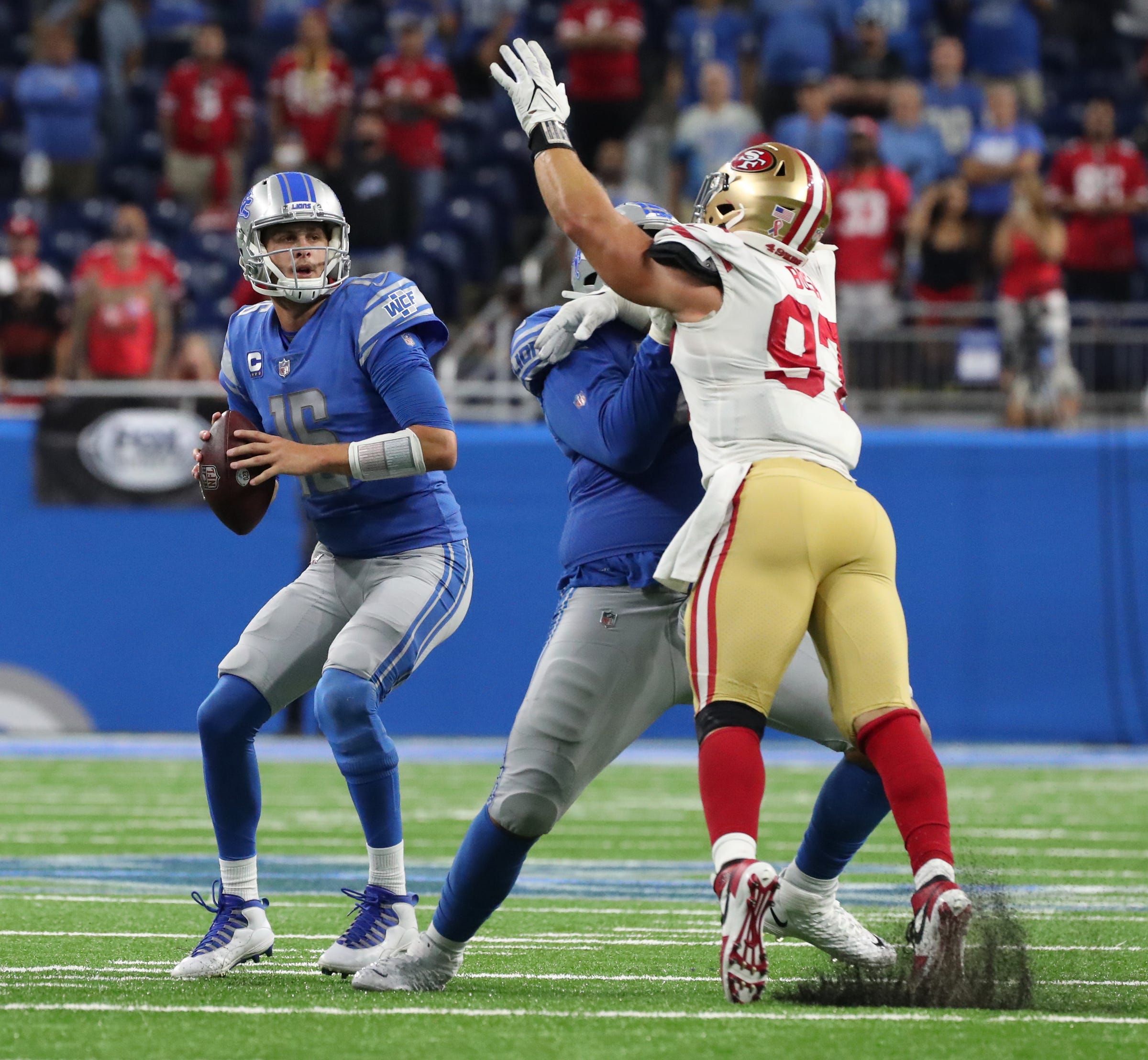 Detroit Lions quarterback Jared Goff is pressured by San Francisco 49ers defensive end Nick Bosa as left tackle Penei Sewell blocks Sunday, Sept. 12, 2021