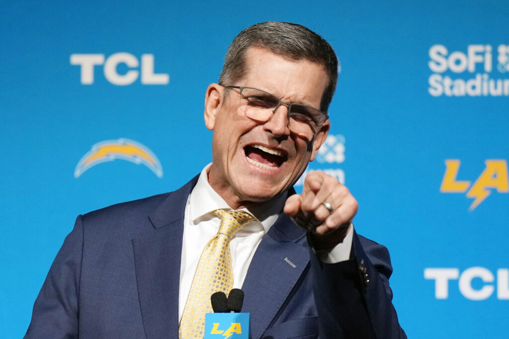 Jim Harbaugh points at crowd during press conference